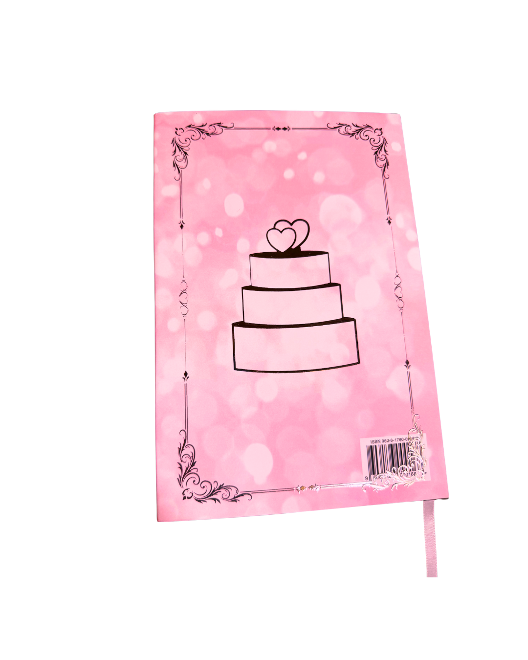 A pink hardcover book featuring silver foil illustration of a three-tiered wedding cake with two hearts on top, framed by an ornate border. 