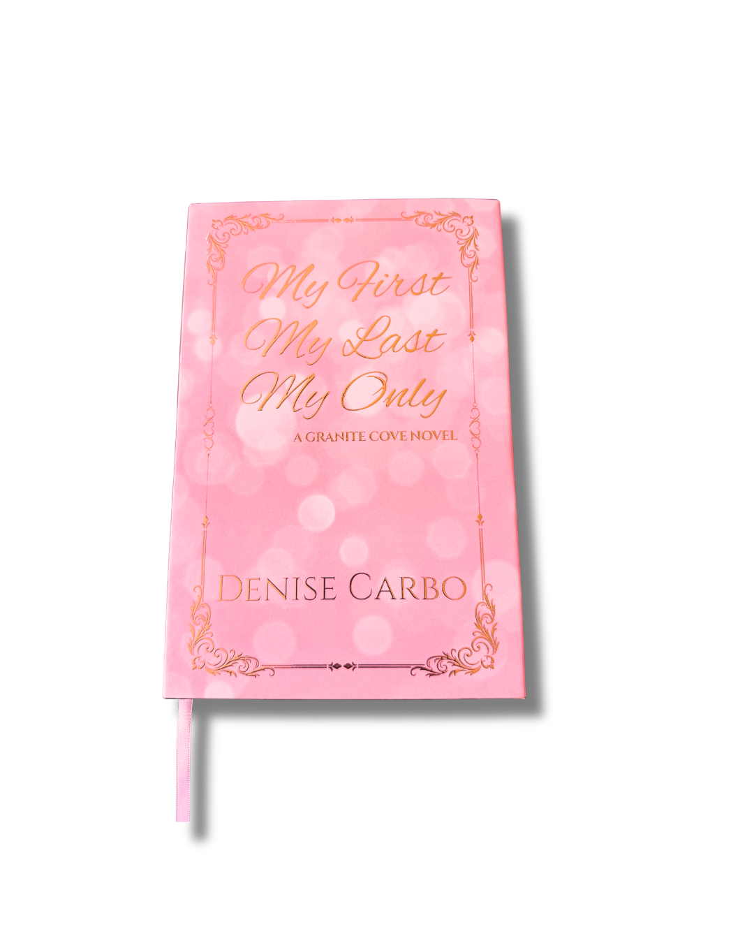 A pink hardcover book with silver foil lettering and border details, titled 'My First My Last My Only' by Denise Carbo, shown on a plain white background with a ribbon bookmark extending from the bottom.